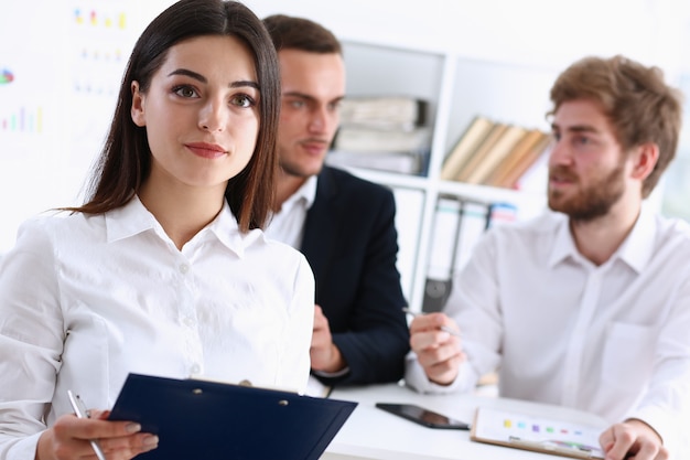 Beautiful smiling cheerful girl at workplace look in camera