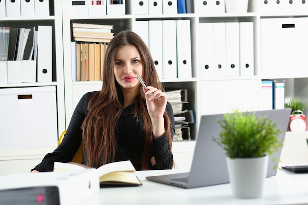 Beautiful smiling clerk woman at workplace talk to visitor