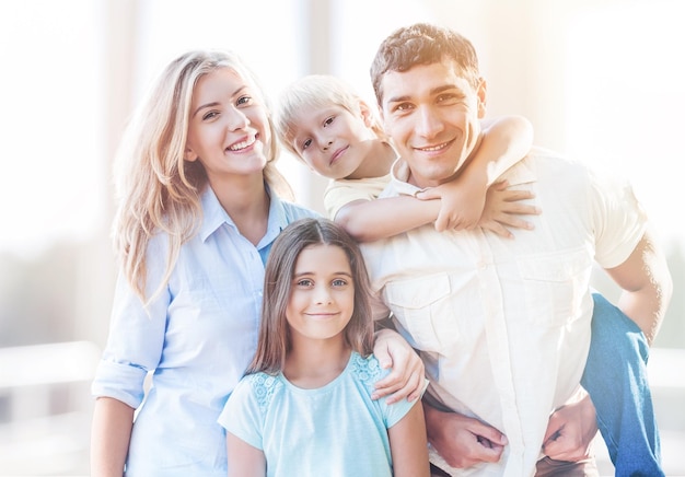 Beautiful smiling family sitting at sofa at home