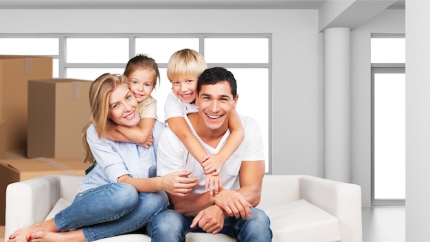 Beautiful smiling family sitting at sofa at home