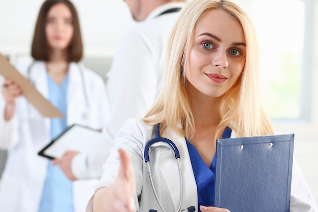 Beautiful smiling female doctor showing ok