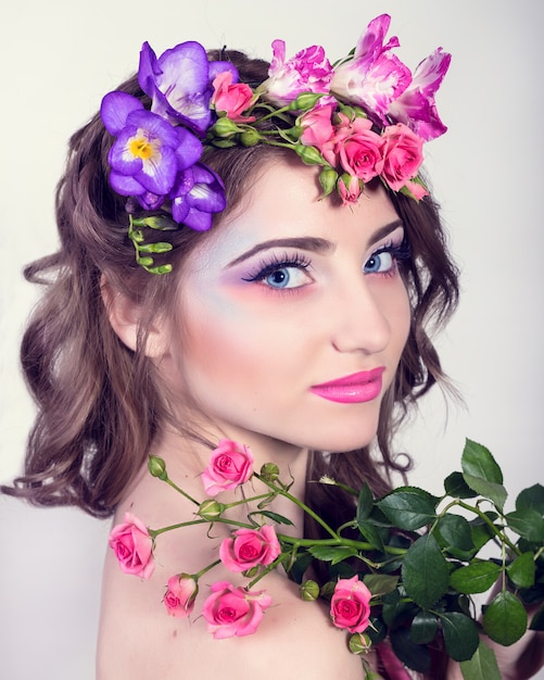 Beautiful smiling girl with flowers in her hair