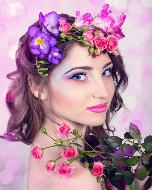 Beautiful smiling girl with flowers in her hair