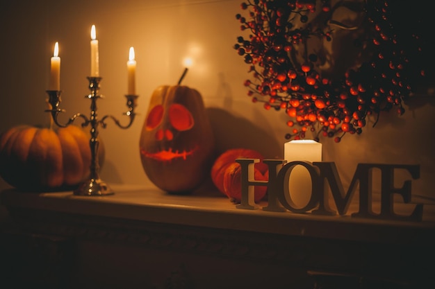 Beautiful smiling orange carved pumpkin jack o lantern for Halloween holiday at night home interior