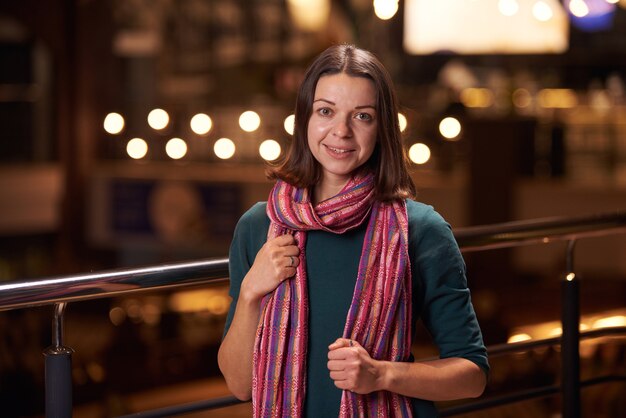 Beautiful smiling woman drinking coffee at cafe. Pretty woman with cup of coffee.