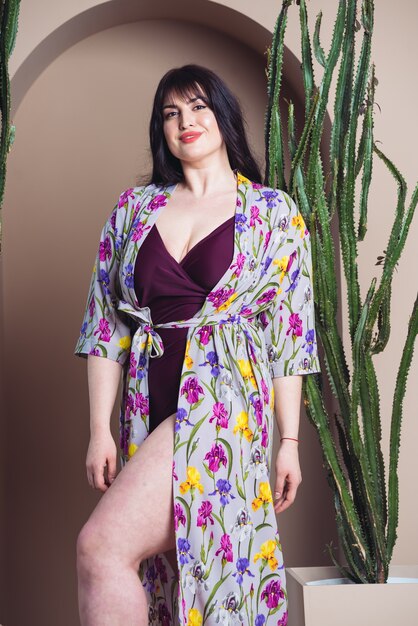 Beautiful smiling woman in a light silk tunic for the beach