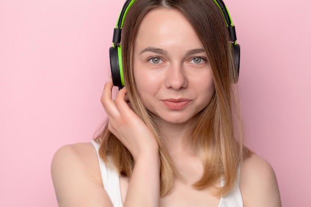 A beautiful smiling woman listening to music audiobook