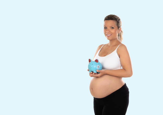 Beautiful smiling woman waiting for baby holding a moneybox