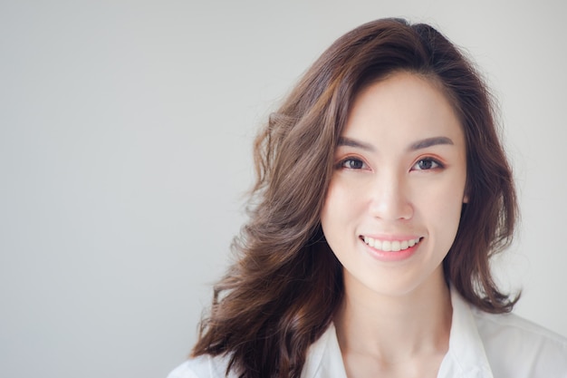 Beautiful smiling woman wearing a white shirt with clean skin