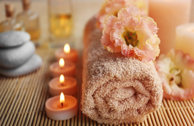 Beautiful spa composition with flowers on mat