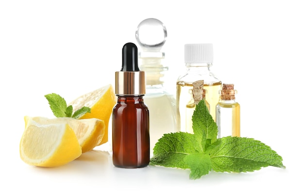 Beautiful spa composition with lemon essential oil on white background closeup