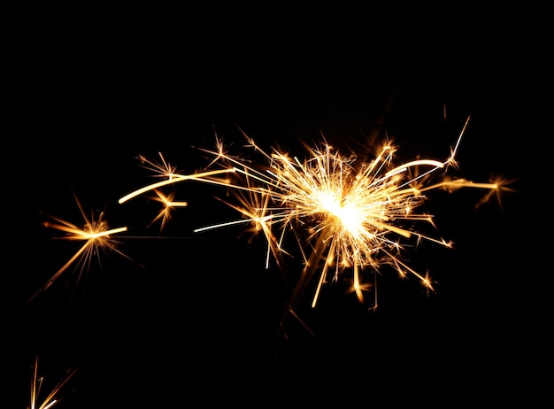 Beautiful sparkler on black surface, close up