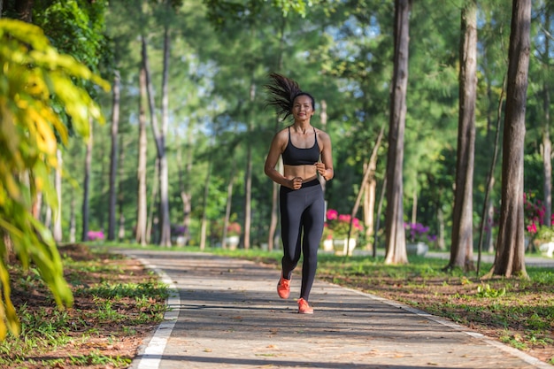 Beautiful Sport woman in sportswear running in the park. Healthy lifestyle and sport concept.