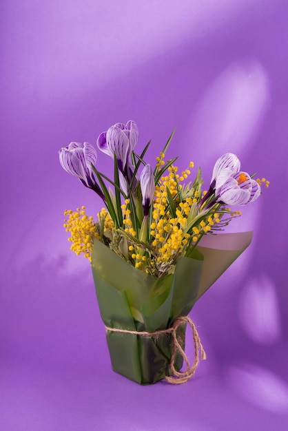 Beautiful spring bouquet of crocuses and mimosa flowers