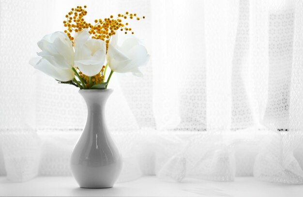 Beautiful spring bouquet in vase on windowsill