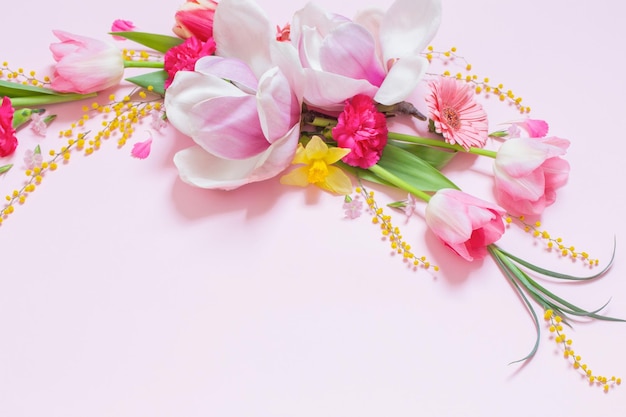 Beautiful spring flowers on pink background