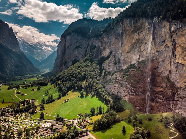 Beautiful Staubbachfall waterfall flowing down the picturesque Lauterbrunnen valley and village in Bern canton