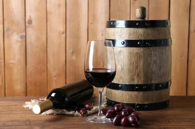 Beautiful still life with wine and grape on wooden table