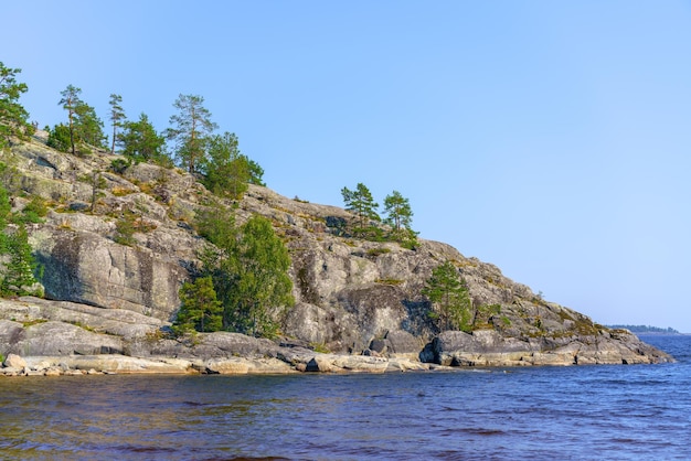 Beautiful stones and pine trees on the lake Landscape of wild nature