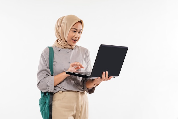 A beautiful student with hijab shocked while opened the laptop