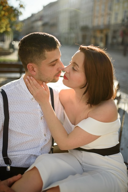 Beautiful stylish couple kissing on a date outdoors in the old city