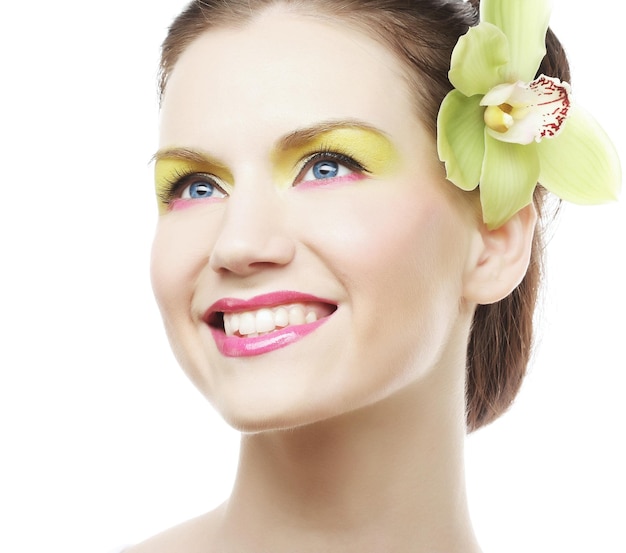 Beautiful stylish girl with orchid flower in hair