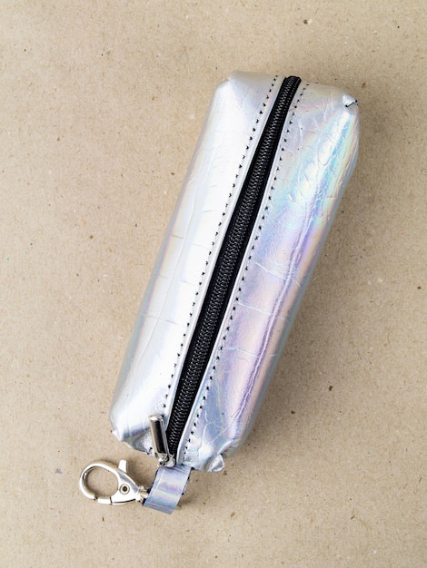 A beautiful and stylish key holder lies on a paper background Closeup photo