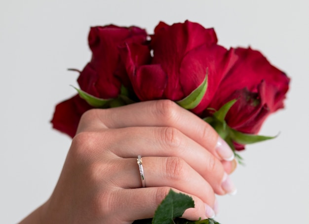 A beautiful stylish ring with diamonds on the finger and beautiful roses