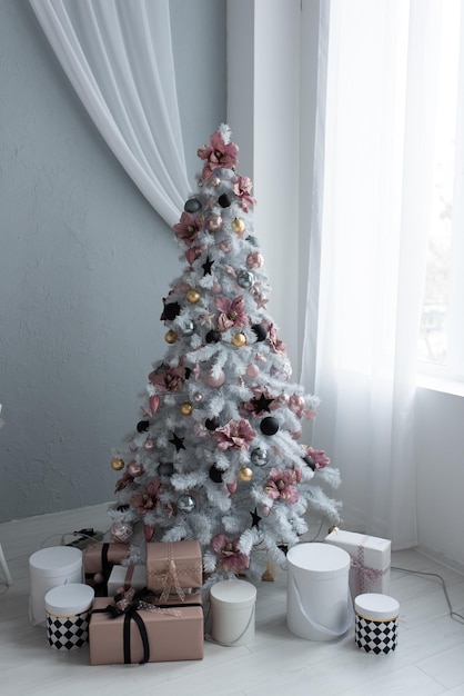 Beautiful stylish room decorated in blue tones The room contains a decorated Christmas tree with gifts and a table with chairs Time before Christmas Template