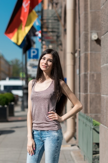 Beautiful stylish woman walking through the city