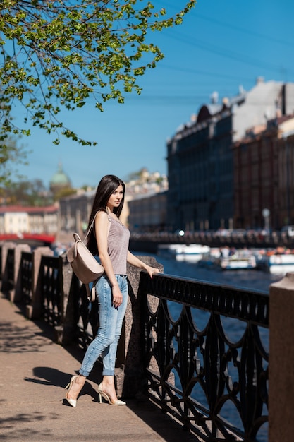 Beautiful stylish woman walking through the city