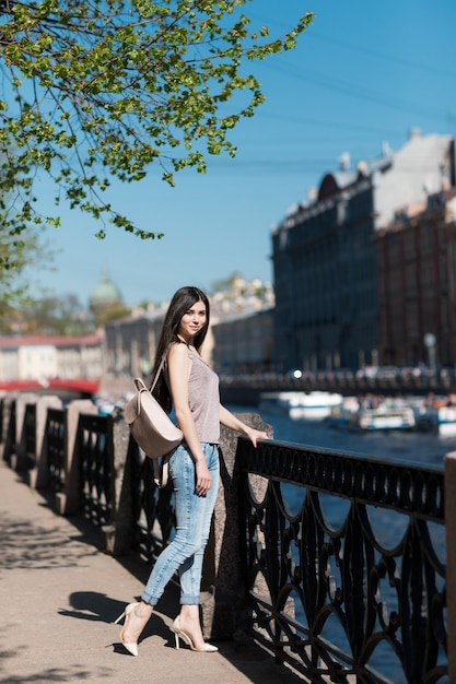 Beautiful stylish woman walking through the city