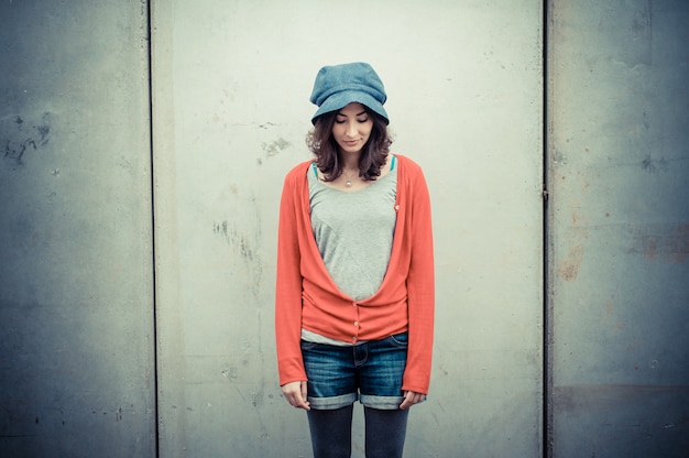 Beautiful stylish woman with wall background