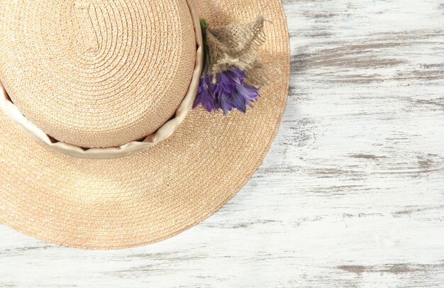 Beautiful summer hat on wooden background