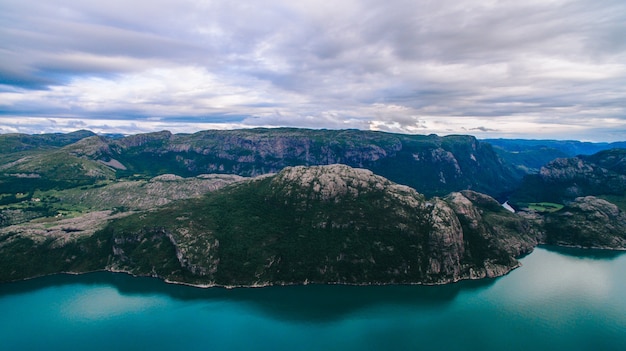 Beautiful summer vibrant view on famous Norwegian tourist place - trolltunga, the trolls tongue with a lake and mountains, Norway, Odda.