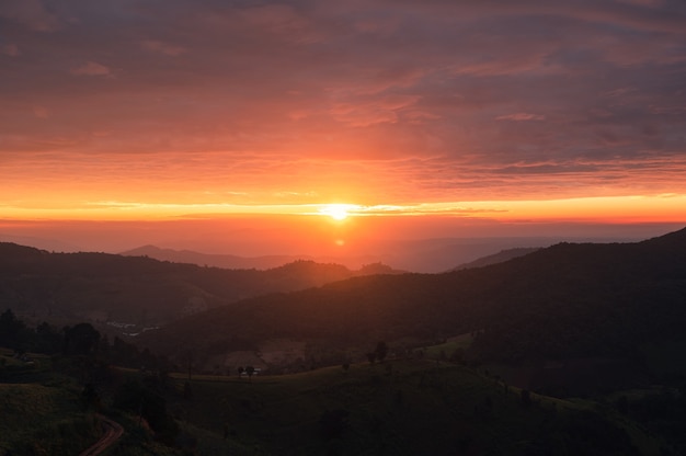 Beautiful sunrise on agricultural hill in countryside at Doi Mae Tho