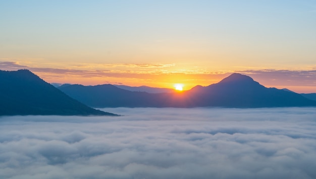 Beautiful sunrise over mountain with fog in the morning