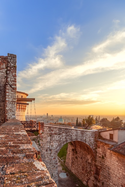 Beautiful sunset over Brescia city view from the old castle. Lombardy, Italy (Vertical photo)