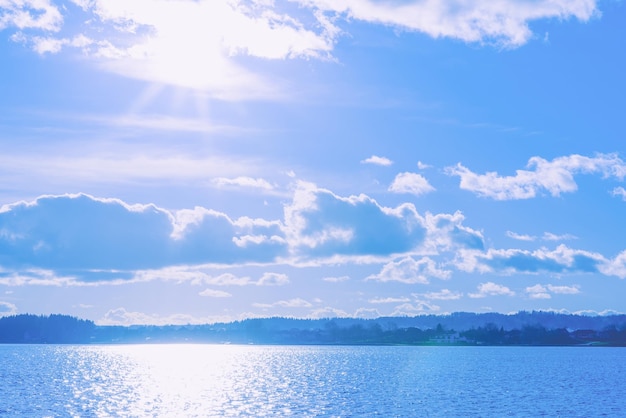 Beautiful sunset in a cloudy sky over the lake On the shore there are treesAwesome landscapeToned