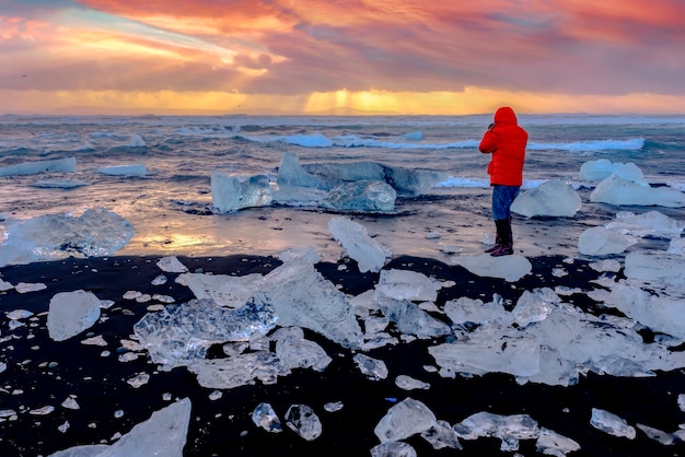 Beautiful sunset over famous Diamond beach, Iceland. This sand lava beach is full of many giant ice gems, placed near glacier lagoon Jokulsarlon Ice rock with black sand beach in southeast Iceland