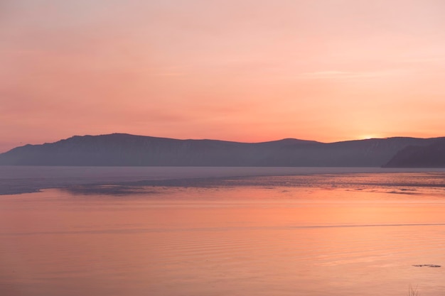 Beautiful sunset on frozen lake baikal winter landscape