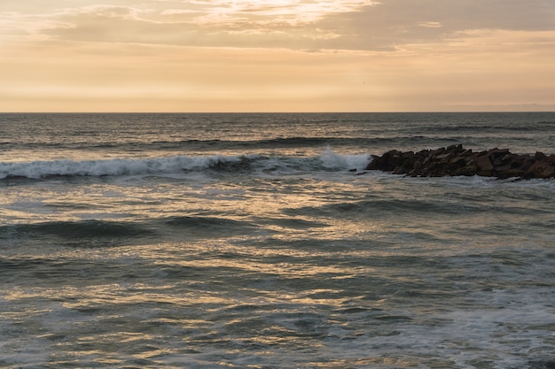 Beautiful sunset in Lima Peru, bright sky and underexposed beach