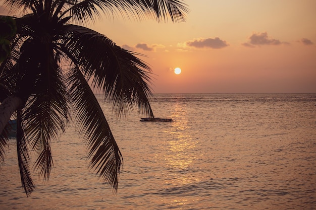 Beautiful sunset in Maldives, orange sky over the sea