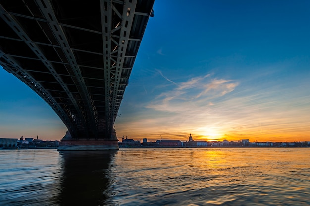 Beautiful sunset over Rhine / Rhein river and old bridge in Mainz near Frankfurt am Main, Germany.