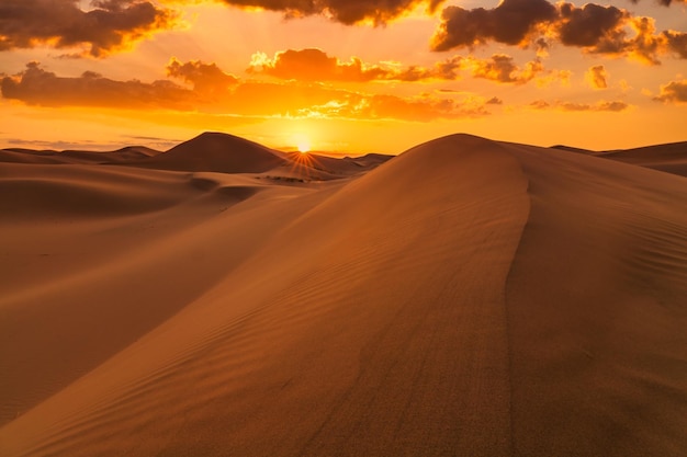 Beautiful sunset over the sand dunes in the Arabian Empty Quarter Desert UAE Rub' al Khali