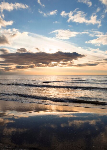 Beautiful sunset on the sandy beach of the Baltic Sea in Lietva Klaipeda