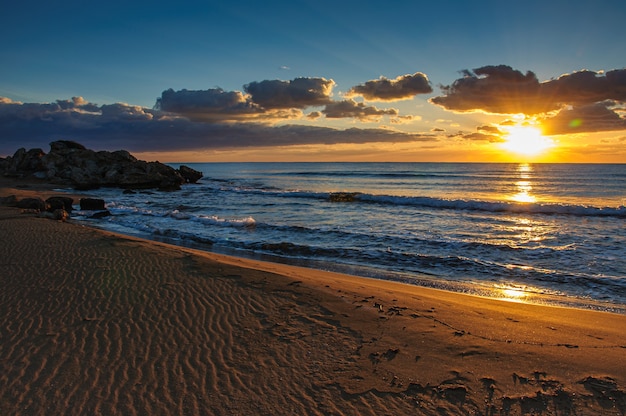 Beautiful sunset over a sandy beach over the mediterranean sea on the island of cyprus