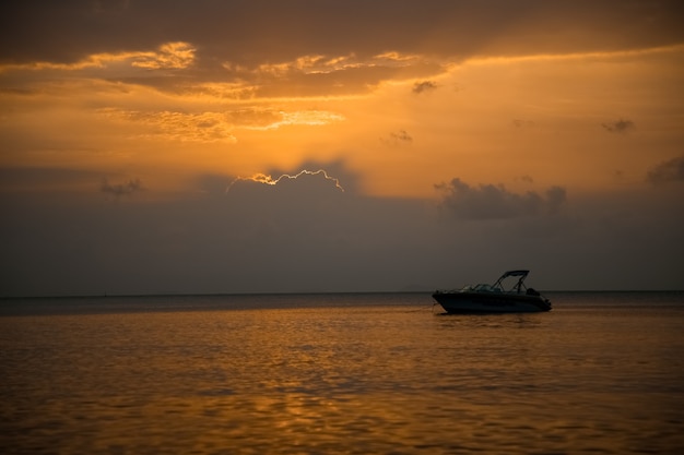 Beautiful sunset at sea speed boat in the rays of the evening sun