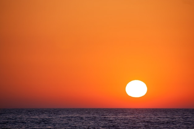 Beautiful sunset over the sea with an orange sky.