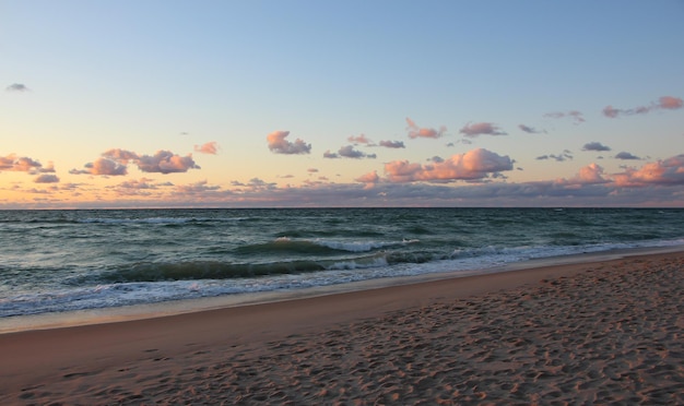 beautiful sunset over the sea with sun reflexes on clouds